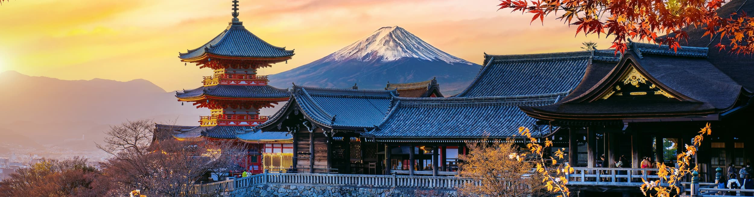 Traditional Japanese houses and autumnal leaves with Mount Fuji in the background