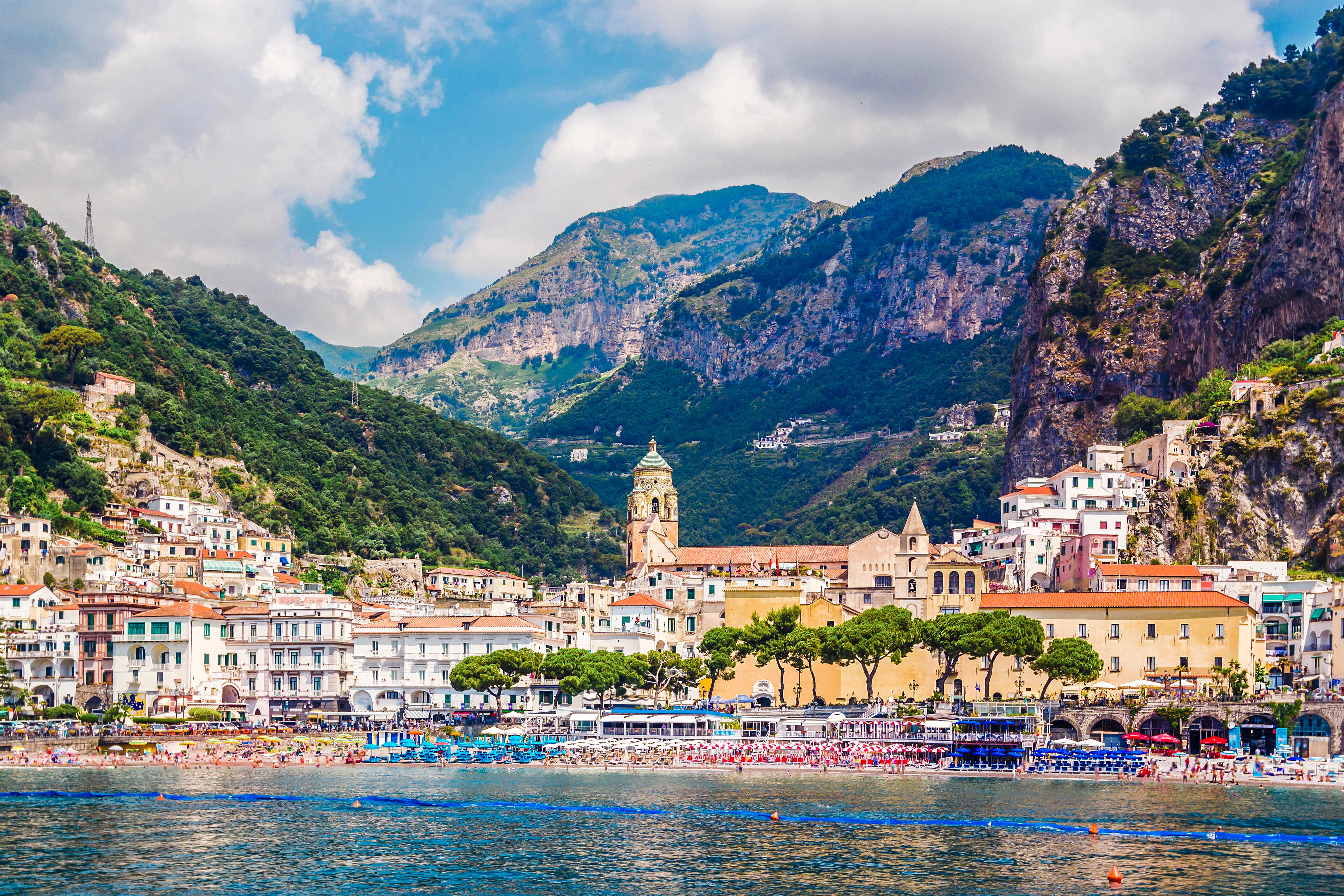 Skyline of colourful Amalfi town, backed by mountains